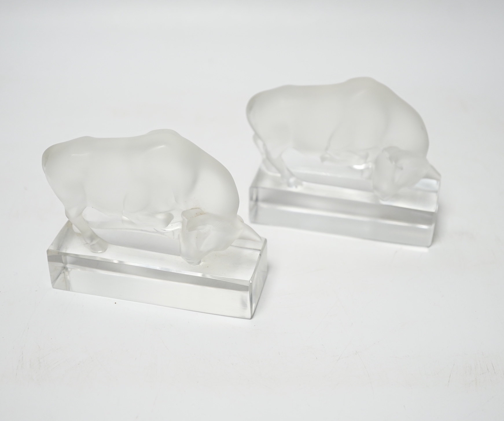 Rene Lalique, two frosted glass paperweights modelled as a bull, signed ‘Lalique France’ to base, 9cm high